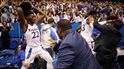 Silvio De Sousa of the Kansas Jayhawks picks up a chair during a brawl as the US college basketball game against the Kansas State Wildcats ends in chaos at Allen Fieldhouse on Tuesday, January 21. AFP