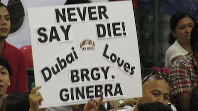 A fan holds up a sign in support of Barangay Ginebra San Miguel during their PBA game against Rain or Shine Elasto Paints in Dubai on Friday. Jonathan Raymond / The National