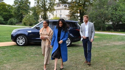 Meghan, Duchess of Sussex, her mother Doria Ragland and Prince Harry arrive at an event to mark the launch of a cookbook with recipes from a group of women affected by the Grenfell Tower fire at Kensington Palace on September 20, 2018 in London, England. Getty Images