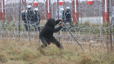 A man breaks a fence at the border. Reuters