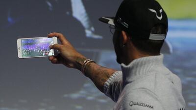 Mercedes Formula One driver Lewis Hamilton of Britain films a video during a keynote speech at the Mobile World Congress in Barcelona, Spain February 23, 2016. REUTERS/Albert Gea