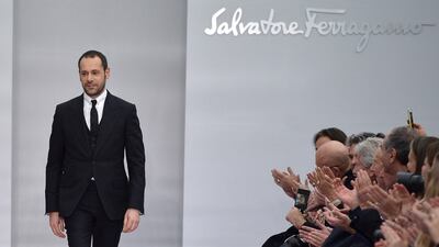 Italian designer Massimiliano Giornetti greets the audience at the end of the show for fashion house Salvatore Ferragamo as part of the Women Autumn / Winter 2016 Milan Fashion Week on February 28, 2016. AFP PHOTO / TIZIANA FABI / AFP / TIZIANA FABI