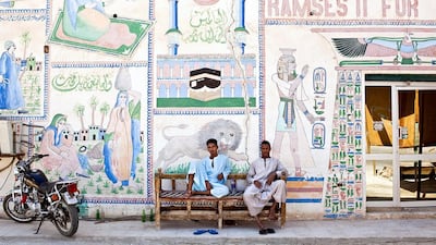 Employees sit and wait for customers outside their tourist store in Luxor, Egypt. Egypt’s government is crowding out private economic activity. Shawn Baldwin / Bloomberg
