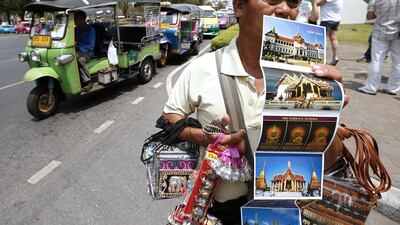 2nd: Bangkok. A Thai souvenir vendor waits for tourists at the entrance gate of the Grand Palace in Bangkok, Thailand. Rungroj Yongrit / EPA