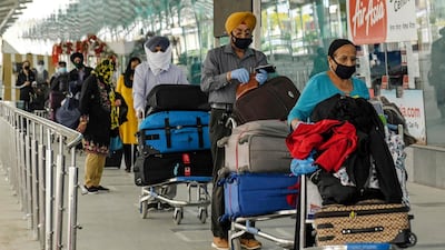Canadian-Indians queue for a special flight from Amritsar to New Delhi and on to their homes in Canada in early April. Flights into India have been suspended since end-March to contain the spread of the coronavirus. AFP