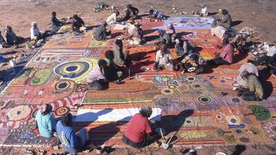 Ngurrara artists producing Ngurrara Canvas II at Pirnini, an area in north west Australia, in May 1997. Photo by K. Dayman (Ngurrara Artists and Mangkaja Arts Resource Agency)