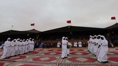 Emiratis perform traditional music and dance. AFP