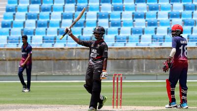 Vriitya Aravind raises his bat after scoring a half century for the UAE. Pawan Singh / The National