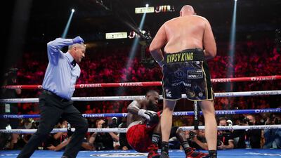 Tyson Fury knocks down Deontay Wilder. Reuters