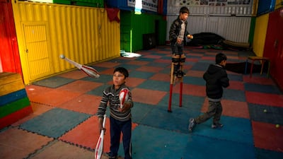 Children learn how to juggle with balls and clubs at the Mobile Mini Circus for Children (MMCC), an Afghanistan's travelling educational entertainment group teaching children aged 5 to 17, in Kabul. AFP
