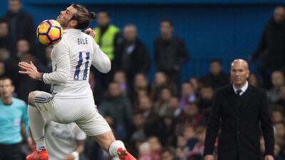 Real Madrid’s Welsh forward Gareth Bale, left, jumps with the ball. Curto de la Torre / AFP