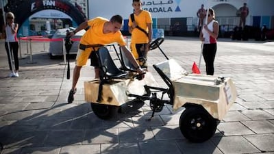 Members of the Falcon 1 team, from Dr Petar Beron High School of Mathematics in Bulgaria, check over their car, the Rub Al Khali. The team went on to win the time trial event.