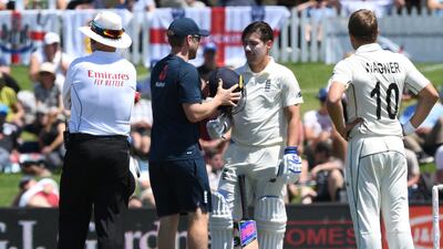 England's Rory Burns is checked by medical staff after being struck on the helmet. Reuters