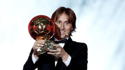 Real Madrid and Croatia's Luka Modric holds the Ballon d'Or award. Reuters