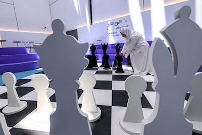 Visitors can test their strategy on a giant chessboard in the exhibition’s interactive play area. Victor Besa / The National