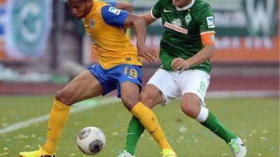 Braunschweig's Simeon Jackson, left, and Bremen's Clemens Fritz tussle for the ball. Peter Steffen / AFP