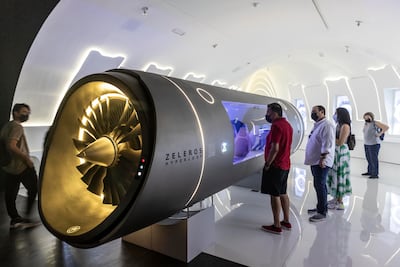 Visitors getting a close-up view of the hyperloop model displayed by Zeleros at the Spain pavilion. Antonie Robertson / The National