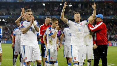 Slovakia's Juraj Kucka, left, and Jan Durica celebrate their side's 2-1 win, at the end of the Euro 2016 Group B soccer match between Russia and Slovakia at the Pierre Mauroy stadium in Villeneuve d’Ascq, near Lille, France, Wednesday, June 15, 2016. (AP Photo/Frank Augstein)