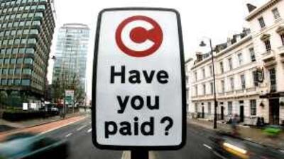 A congestion charge payment reminder sign in the UK. The fee was imposed to encourage the use of public transport.