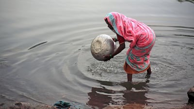 A woman collects unfiltered water for drinking from a lake in Jharia, India. Subhash Sharma for the National