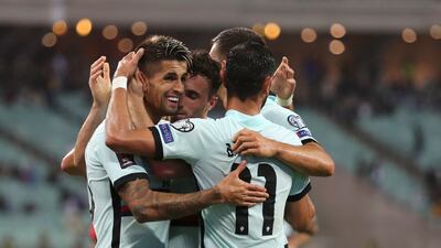 Portugal players celebrate after Diogo Jota scored his side's third goal. AP