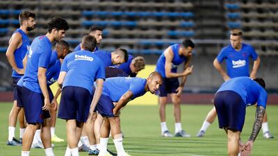 Barcelona players warm up during a training session at the Machida Municipal Athletic Stadium. AP Photo