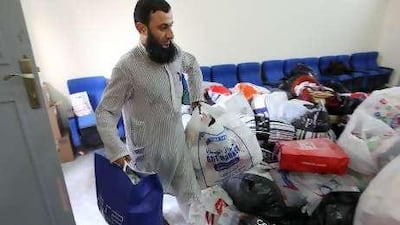 Zahoor Uddin Khan, a volunteer, sorts clothing, medicines and food items at the Pakistan Association Dubai.