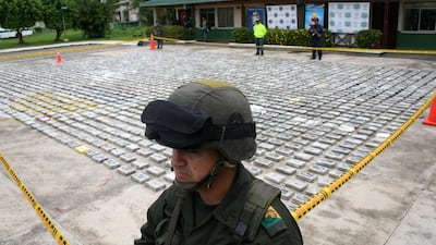A soldier guards packets of cocaine in Colombia in 2011. Nestor Silva / AFP