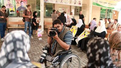Palestinian freelance photographer Moamen Qreiqea takes pictures of protesters calling for the release of Palestinian prisoners from Israeli jails.