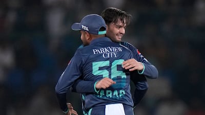 Pakistan's Usman Qadir, right, hugs captain Babar Azam after the dismissal of England's Dawid Malan. AP