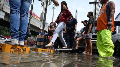 Commuters use upturned crates as stepping stones. AFP