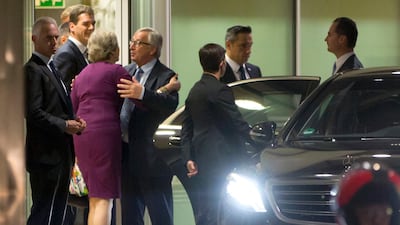 European Commission President Jean-Claude Juncker embraces British Prime Minister Theresa May after a meeting at EU headquarters in Brussels on Monday, Oct. 16, 2017. AP Photo/Virginia Mayo