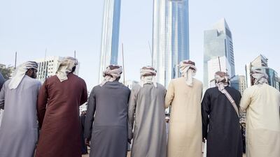 A group of men perform a traditional dance. Reem Mohammed / The National