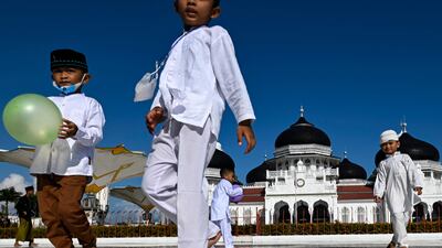 Children play on the grounds of the Baiturrahman Grand Mosque before the start of Ramadan in Banda Aceh. Indonesia recently lifted restrictions to allow the resumption of traditional practices for the holy month. AFP