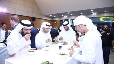 UAE officials and journalists eat bibimbap, a traditional Korean dish, during an iftar at the Korean embassy in Abu Dhabi. EPA