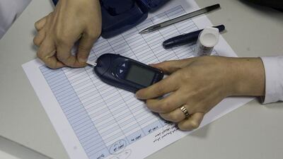 A glucometer, a device used to measure the level of glucose in the blood, is demonstrated at the Imperial College London Diabetes Centre in Abu Dhabi.