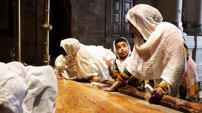 A child visits the Stone of Unction with her mother at the Church of Holy Sepulchre, in the Old City of Jerusalem, where many Christians believe Jesus was crucified, buried and rose from the dead. AP Photo