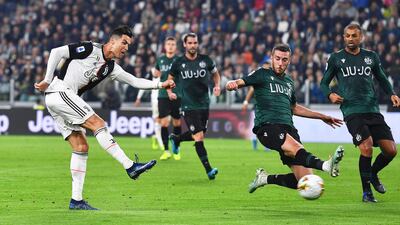 Juventus' Cristiano Ronaldo (L) scores the 1-0 lead during the Italian Serie A soccer match between Juventus FC and Bologna FC in Turin, Italy. EPA