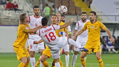 Syria's midfielder Zaher Midani jumps for the ball. AFP