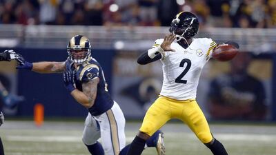 Pittsburgh Steelers quarterback Michael Vick, right, throws under pressure during his team's NFL game against the St Louis Rams on Sunday. Billy Hurst / AP / September 27, 2015