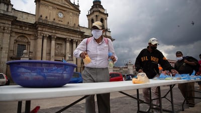 Unemployed people affected by the restrictions put in place to prevent the spread of the new coronavirus take food donated by a Catholic family in front of the Metropolitan Cathedral in Guatemala City, Guatemala. AP Photo