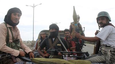 Members of the Popular Committees, supporters of president Abdrabu Mansur Hadi, sit in a pick-up truck as they arrive on March 23 in the city of Lahj. AFP