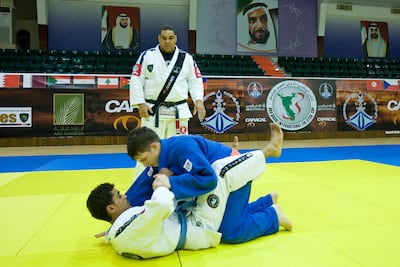 The National first visited Abu Dhabi Combat Club in 2008 to see Laith Al Sharjit (in blue), then 15, sparring with Ahmed Al Mazam (in white), then 22, as instructor Carlos Santos watches. Philip Cheung / The National