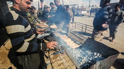 Hashed al-Shaabi (Popular Mobilisation) paramilitaries prepare food for fighters in Tal Abta district, west of Mosul, where Iraqi forces are preparing for the battle to retake the western side of the city, on February 17, 2017. Ahmad Al Rubaye / AFP