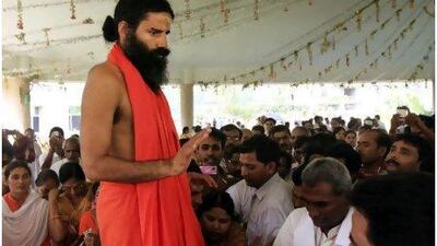Yoga guru Baba Ramdev tells followers at his ashram in Haridwar yesterday that he would continue a hunger strike in protest at corruption in India.