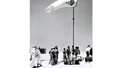 Passengers wait with their suitcases for a flight at Abu Dhabi's sand airstrip. Photo: BP Archive