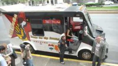 The art show creator Nato Thompson, right, and the artist Aaron Gach in a fake police uniform beside the ice cream van.