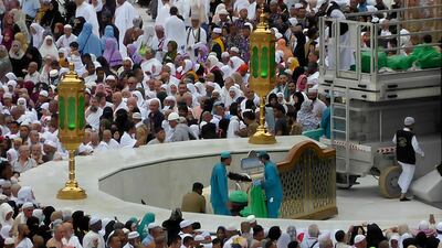 Workers clean as Muslim pilgrims circumambulate around the Kaaba in Mecca on Monday. AP Photo