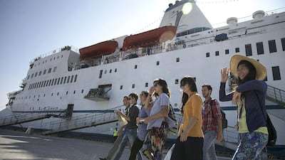 Volunteers for the Logos Hope head ashore to welcome visitors yesterday after the ship docked at Mina Zayed in Abu Dhabi. Silvia Razgova / The National