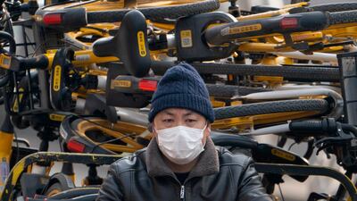 A worker drives a cart loaded with rental bicycles in Beijing, China. AP Photo